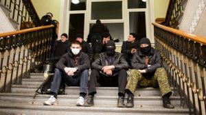 Pro-Russian protesters sit inside the seized regional administrative building in Kharkiv