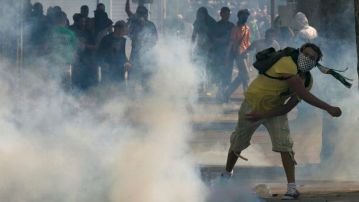 A pro-Palestinian protester throws a projectile during a demonstration against violence in the Gaza strip in Paris